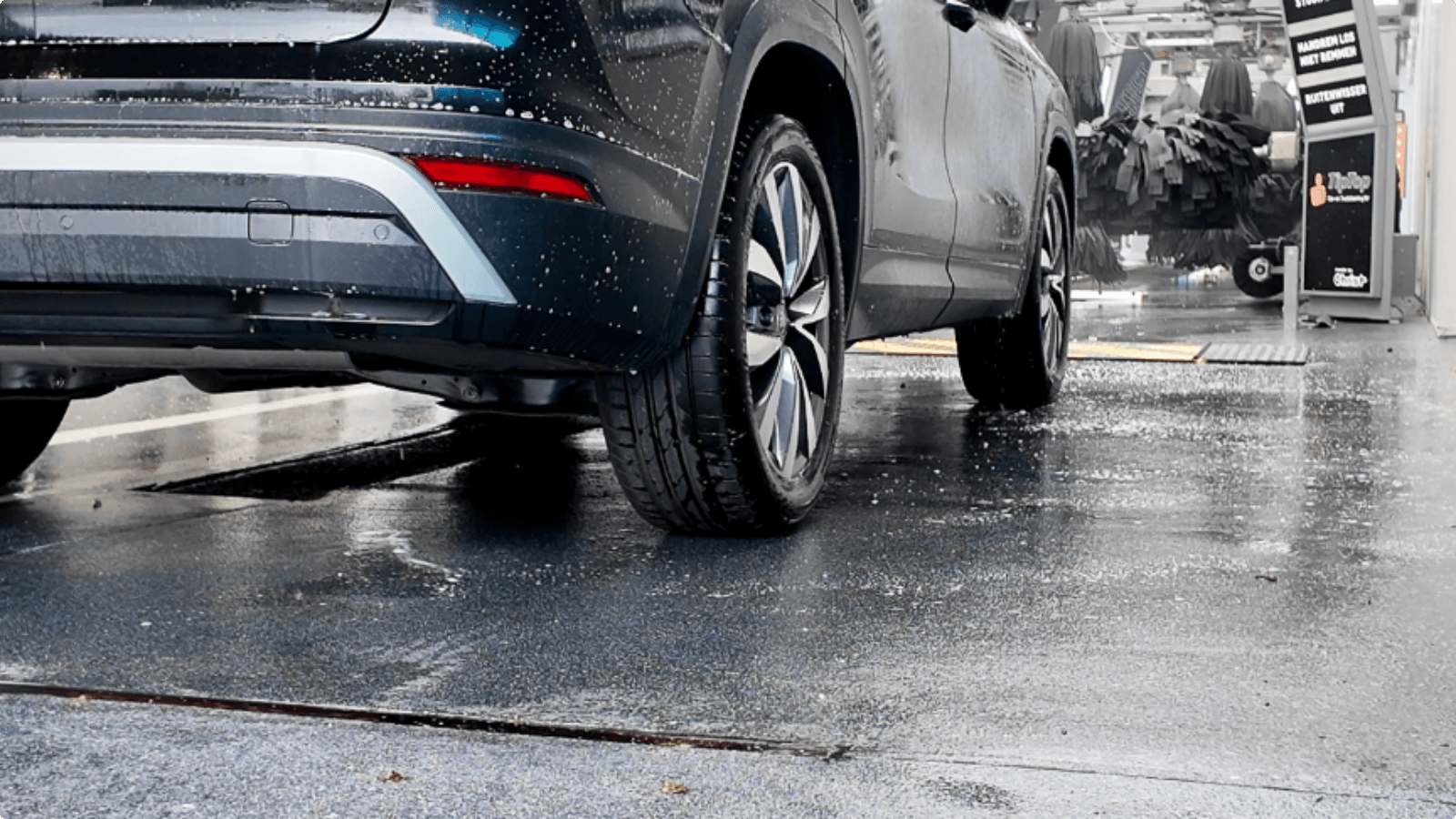 Auto rijdt over een slijtvaste Duraquartz Torffelvloer bij de uitgang van de wasstraat van TipTop Carwash
